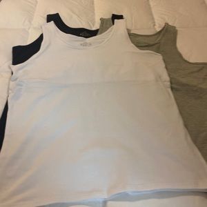 Three sleeveless tees tank tops with built in bras.